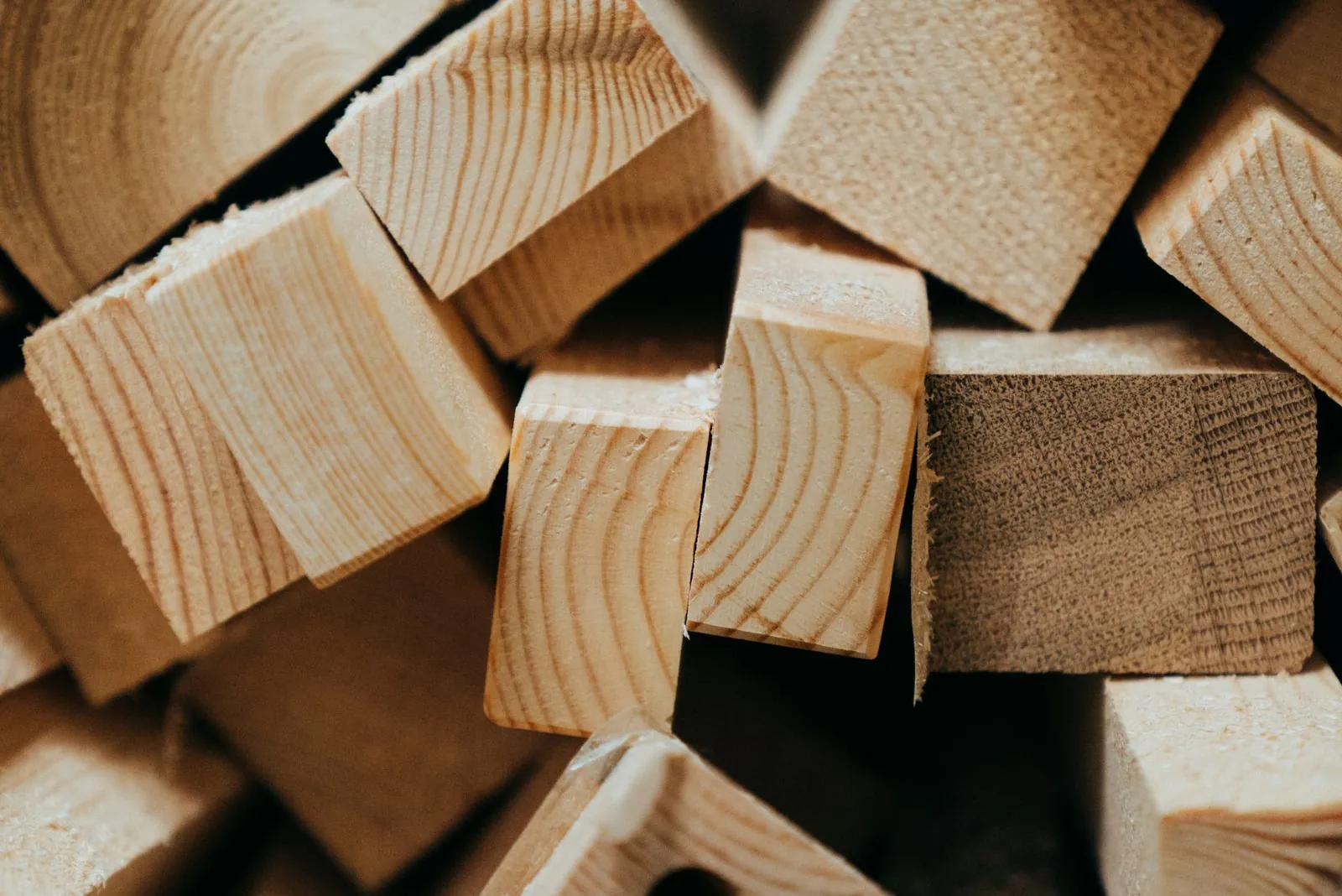 Close-up of a pile of timber offcut blocks showing their end grain